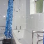The bathroom has a bath and shower, and if fully tiled for easy cleaning.