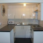 Good sized kitchen for a 1-bedroom flat, equipped with cooker, fridge freezer